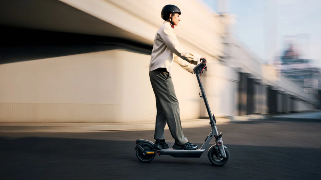 Conducteur roulant en ville sur la Segway Ninebot F3 avec casque de sécurité
